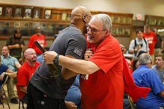 Staff photo by Olivia Ross / Kelvin Allen, left, hugs Johnny Meeks as results come in April 19 from the Volkswagen Chattanooga union election. The United Auto Workers won the vote, and the parties are readying to start contract negotiations.